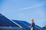 man worker firld by solar panels 1 SunPower Bankruptcy Solar maintenance NJ,solar panel cleaning services NJ,inverter inspection NJ,solar energy system maintenance,emergency solar repairs NJ SunPower Bankruptcy: What Homeowners Should Know, Expect, and Do Next